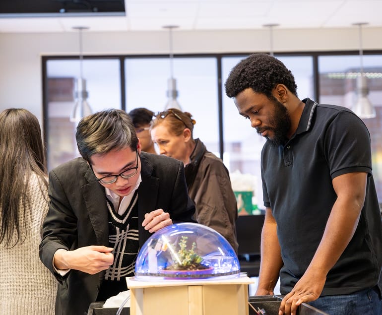 Students present their prototype at a project showcase.